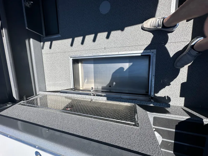 Slide: The Image of 2024 Spartan 220 Maximus boat deck with storage compartments. - 16