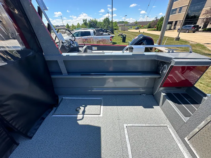 Slide: The Image of 2024 Spartan 220 Maximus boat interior with seating and storage compartments. - 17