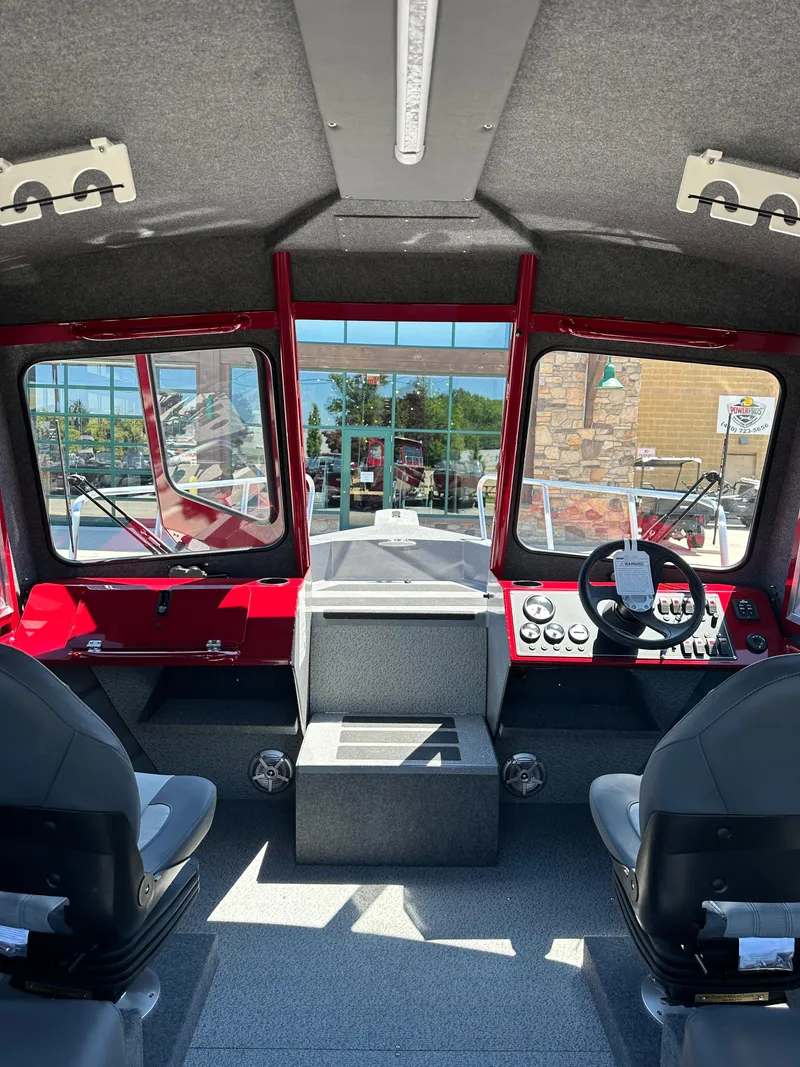 Slide: The Image of Interior of 2024 Spartan 220 Maximus boat with dual seats and control panel. - 24