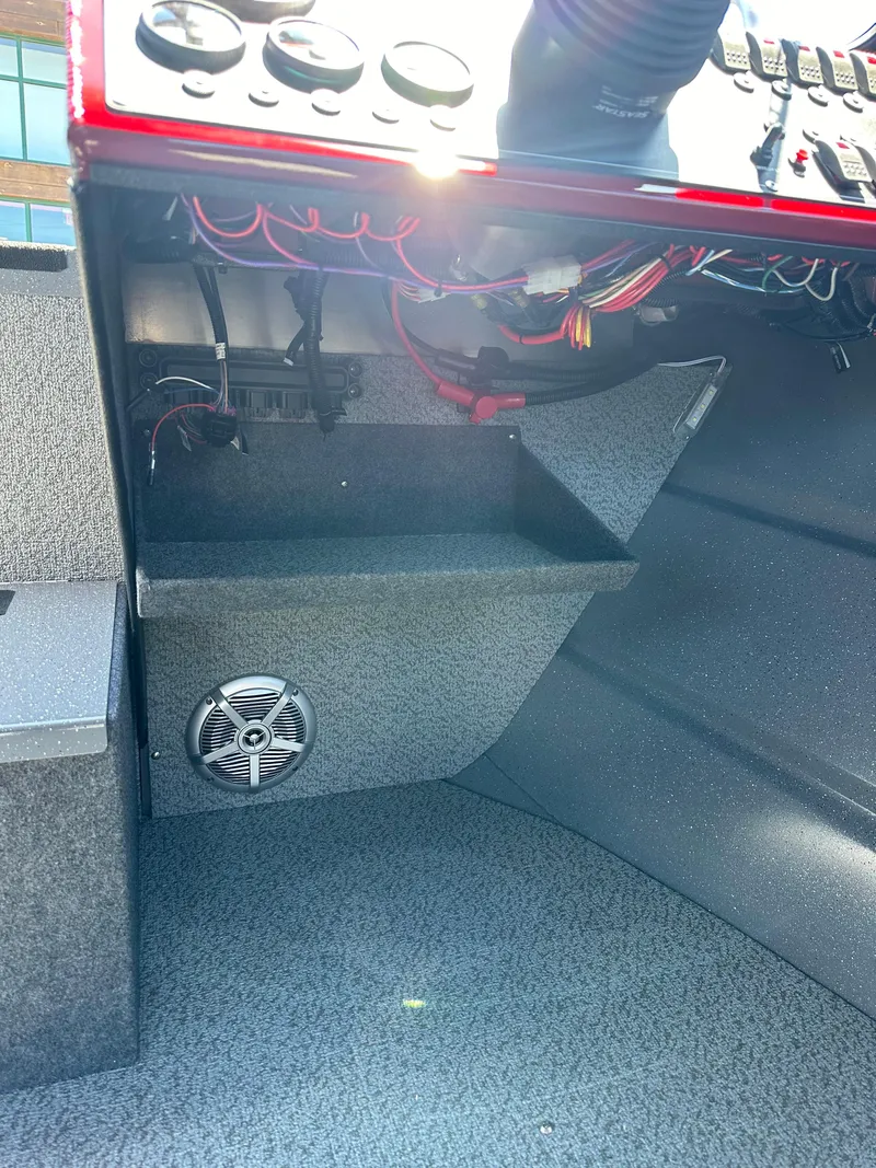 Slide: The Image of 2024 Spartan 220 Maximus boat dashboard with wiring and speaker. - 29