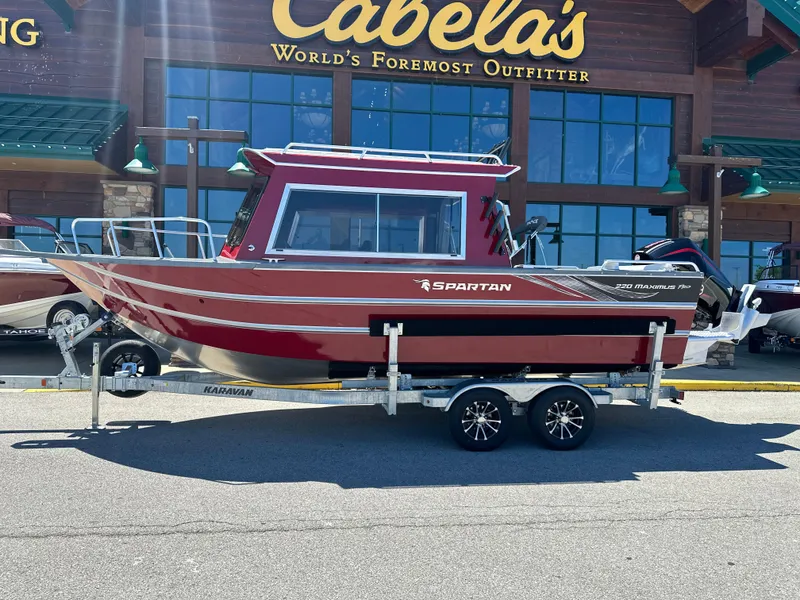 Slide: The Image of 2024 Spartan 220 Maximus boat on trailer outside Cabela's store. - 3
