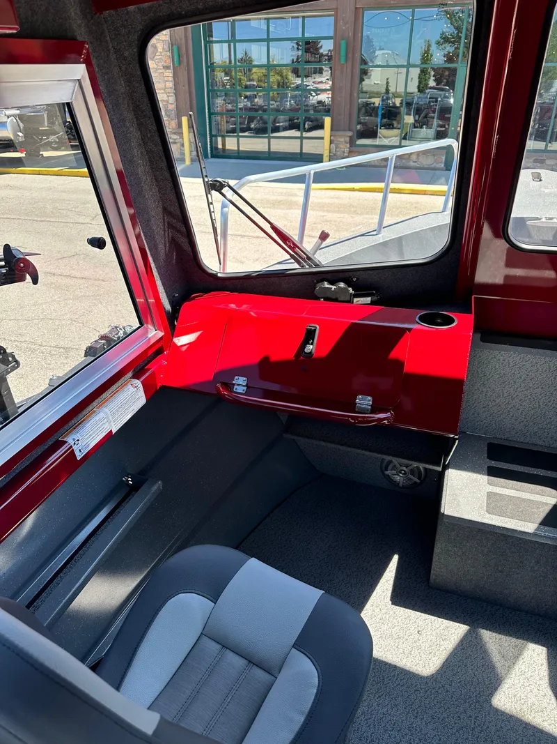 Slide: The Image of Interior of 2024 Spartan 220 Maximus boat with red dashboard and gray seating. - 33