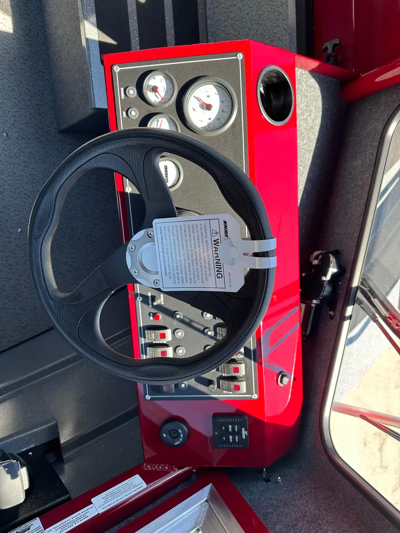 Slide: The Image of 2024 Spartan 220 Maximus dashboard with steering wheel and control panel. - 35