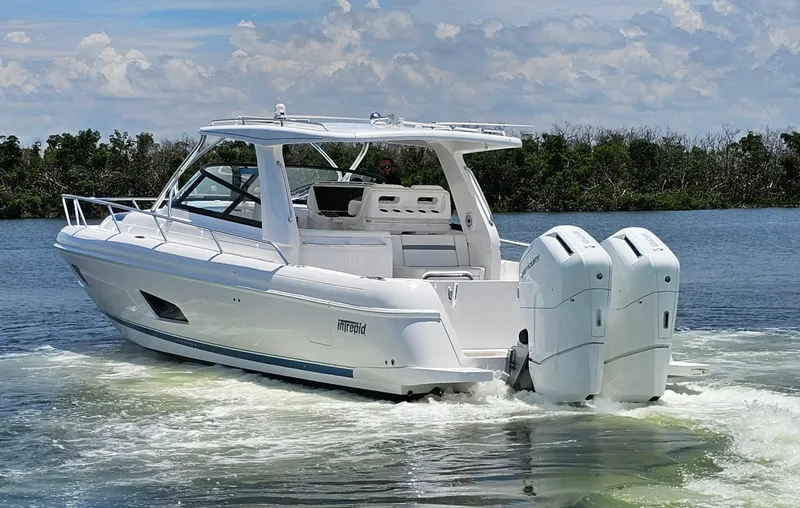 Slide: The Image of 2022 Intrepid 438 Evolution boat cruising on a lake. - 0