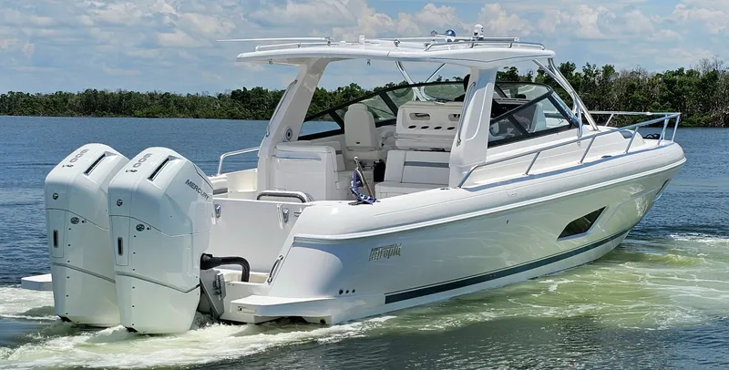 Slide: The Image of 2022 Intrepid 438 Evolution boat cruising on a lake. - 1