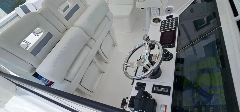 Slide: The Image of 2022 Intrepid 438 Evolution boat cockpit with steering wheel and control panel. - 12