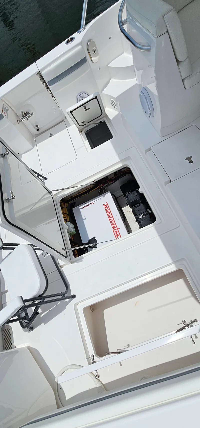 Slide: The Image of 2022 Intrepid 438 Evolution boat interior with open compartments and seating. - 14