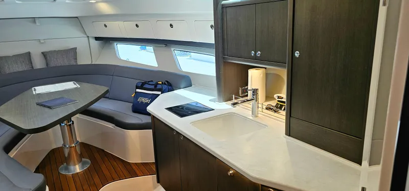 Slide: The Image of Modern interior of 2022 Intrepid 438 Evolution yacht with kitchen and seating area. - 16