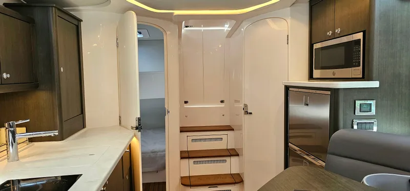 Slide: The Image of Interior of 2022 Intrepid 438 Evolution yacht with modern kitchen and cozy cabin. - 17
