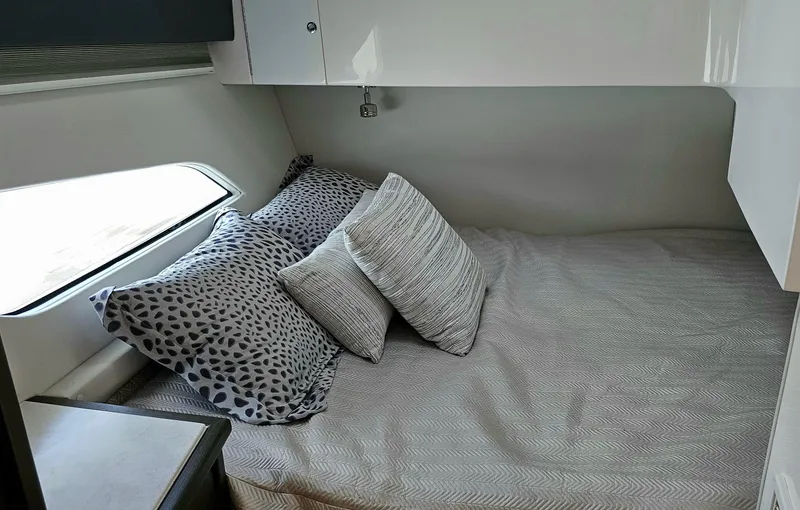 Slide: The Image of 2022 Intrepid 438 Evolution cabin bed with pillows and side window. - 19