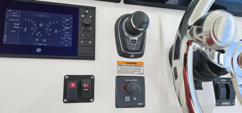 Slide: The Image of Control panel of 2022 Intrepid 438 Evolution boat with steering wheel and display. - 22