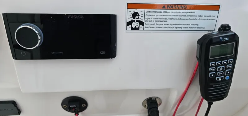 Slide: The Image of Control panel of a 2022 Intrepid 438 Evolution boat with Fusion and Icom devices. - 23