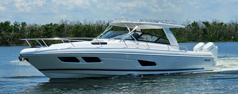 Slide: The Image of 2022 Intrepid 438 Evolution luxury boat cruising on water. - 3