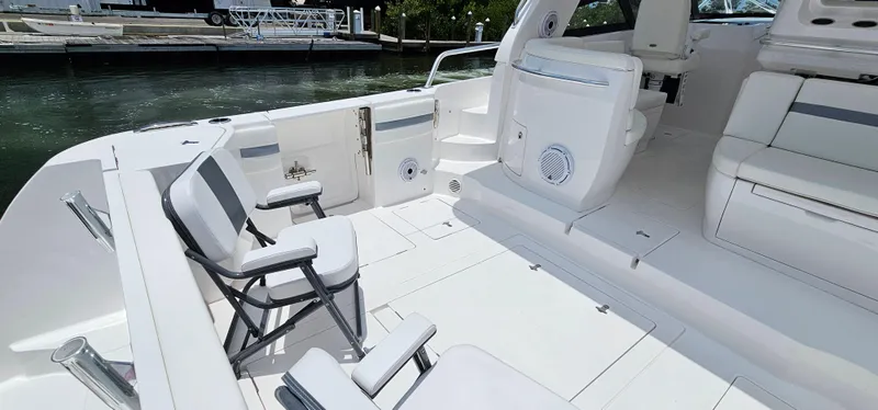 Slide: The Image of 2022 Intrepid 438 Evolution boat interior with white seating and deck. - 6