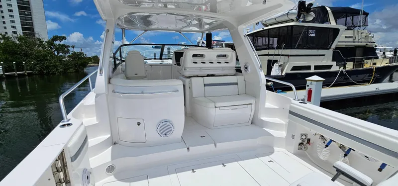 Slide: The Image of 2022 Intrepid 438 Evolution yacht interior with seating and control panel. - 8