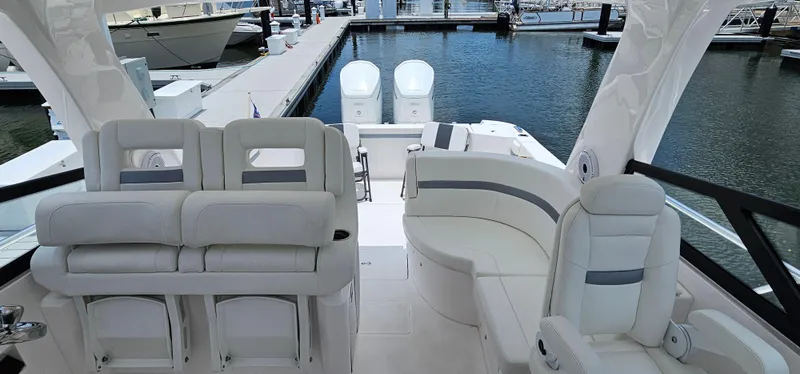 Slide: The Image of 2022 Intrepid 438 Evolution luxury boat interior with plush seating at the marina. - 9