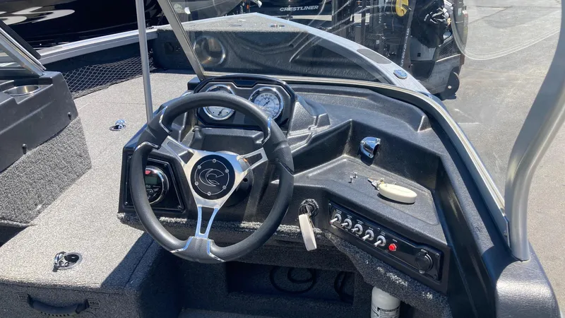 Slide: The Image of 2021 Crestliner 1750 Fish Hawk WT JS boat dashboard with steering wheel and control panel. - 6