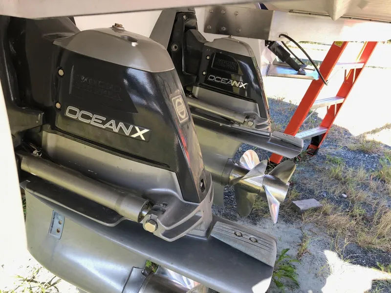 Slide: The Image of 2016 Cobalt 302 OceanX outdrives with stainless steel propellers, parked on a trailer. - 8