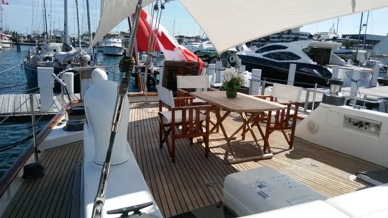 Slide: The Image of Luxurious 1986 Stephens Deck Saloon yacht with elegant outdoor seating and marina view. - 22