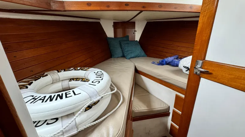Slide: The Image of Cozy cabin interior of 1969 Grand Banks 42 Classic with life rings and cushions. - 12