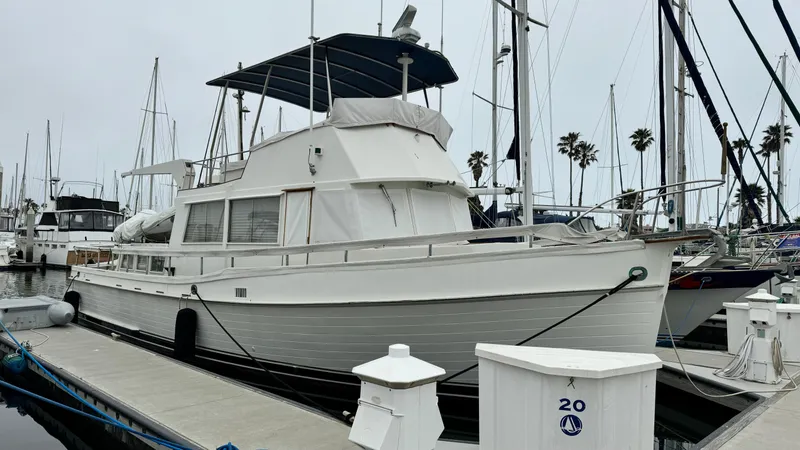 Slide: The Image of 1969 Grand Banks 42 Classic yacht docked at marina, featuring elegant design and spacious deck. - 2