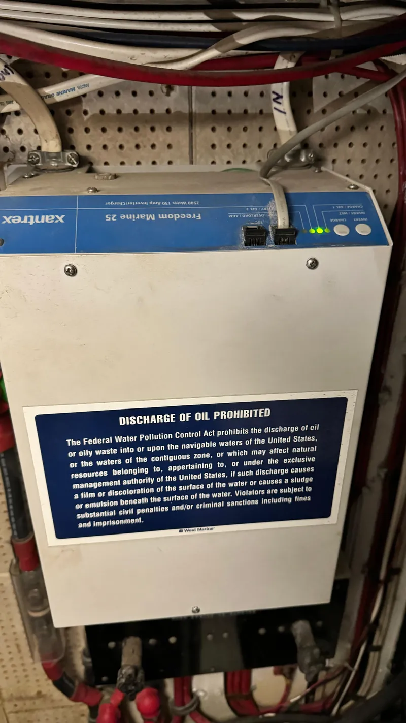 Slide: The Image of Electrical panel with oil discharge warning on a 1969 Grand Banks 42 Classic boat. - 21