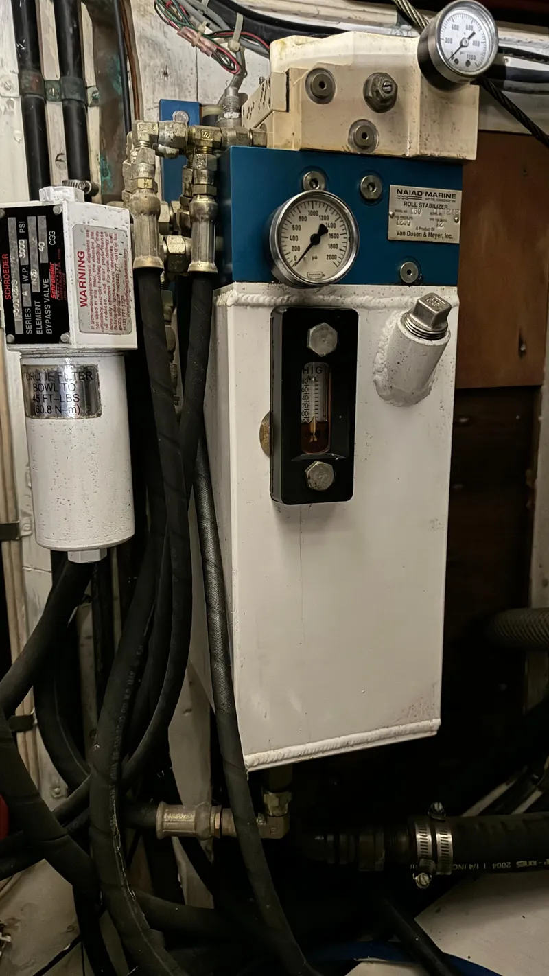 Slide: The Image of Engine room equipment on a 1969 Grand Banks 42 Classic boat, featuring gauges and hoses. - 22