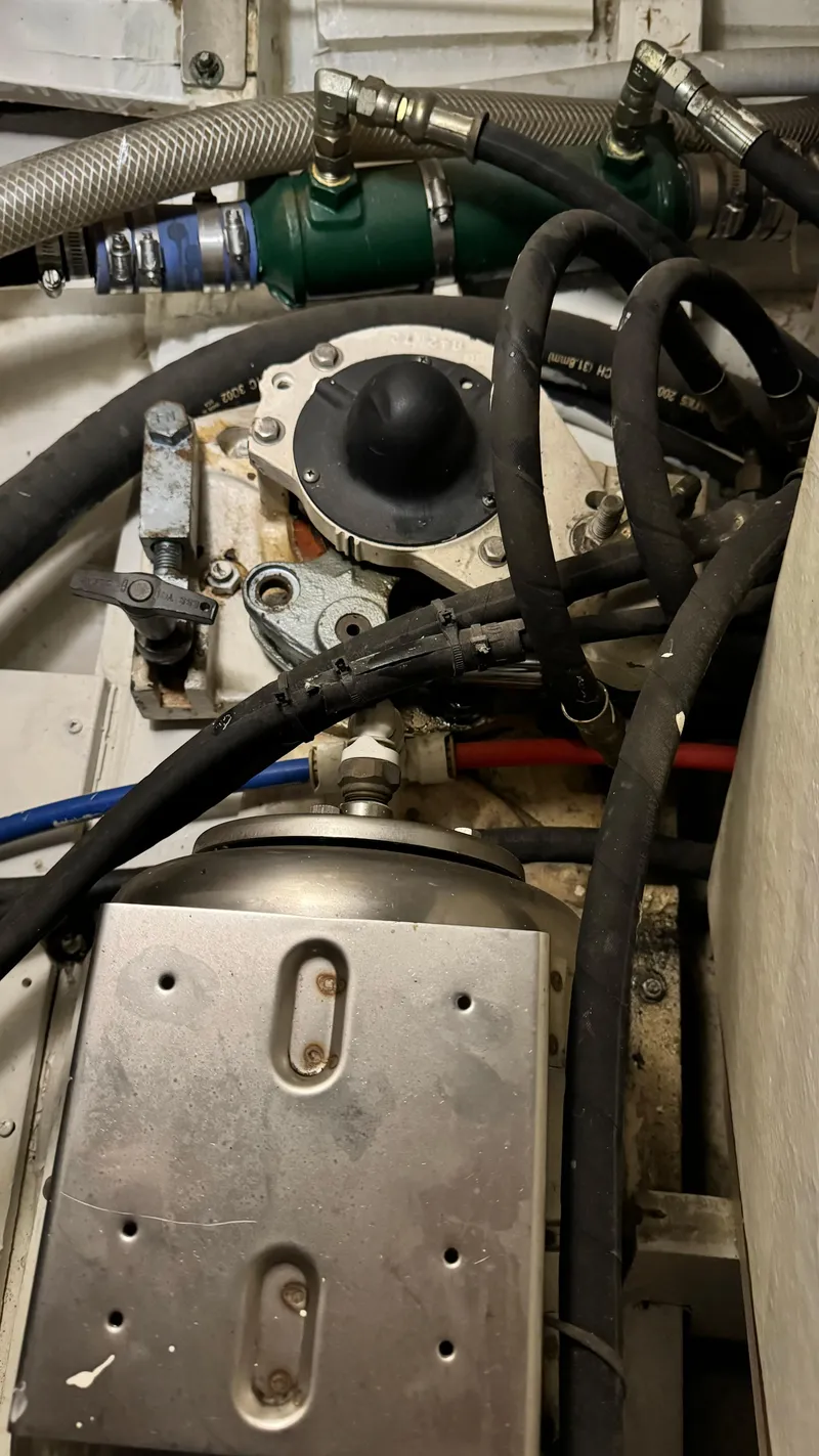 Slide: The Image of Engine room of a 1969 Grand Banks 42 Classic boat, showing mechanical components and hoses. - 24