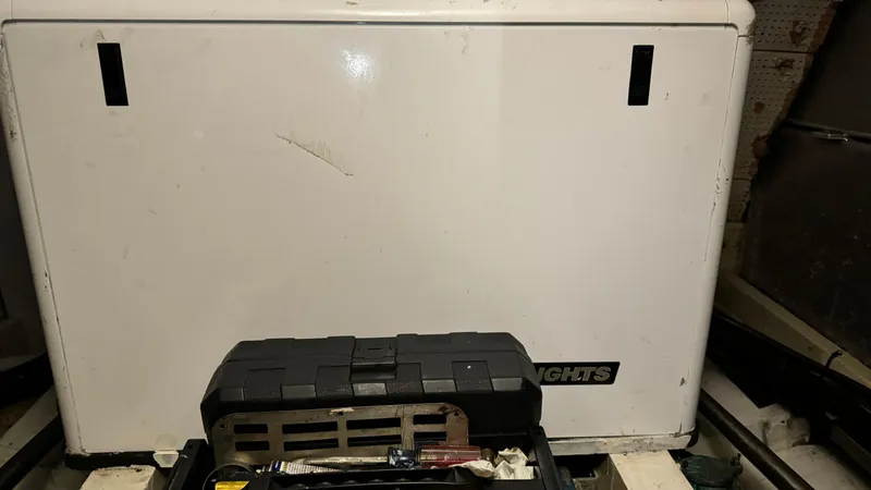 Slide: The Image of Toolbox in front of a Grand Banks 42 Classic engine compartment, 1969 model. - 25