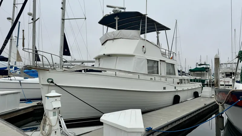 Slide: The Image of 1969 Grand Banks 42 Classic yacht docked at a marina, showcasing its timeless design. - 27