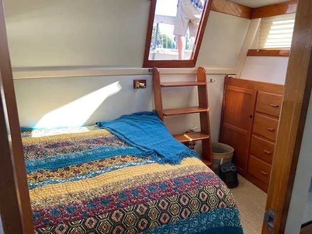 Slide: The Image of Cozy cabin interior of 1969 Grand Banks 42 Classic with colorful bedding and wooden accents. - 28
