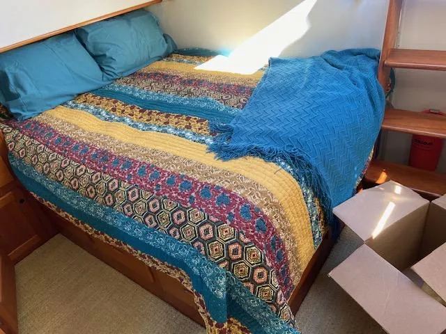 Slide: The Image of Cozy bedroom with colorful bedding on a 1969 Grand Banks 42 Classic boat. - 29