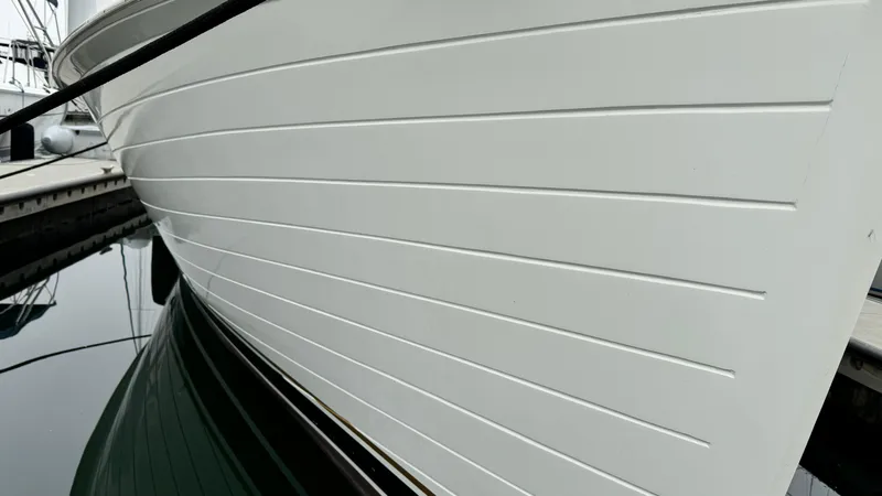 Slide: The Image of Side view of a 1969 Grand Banks 42 Classic yacht docked at a marina. - 3