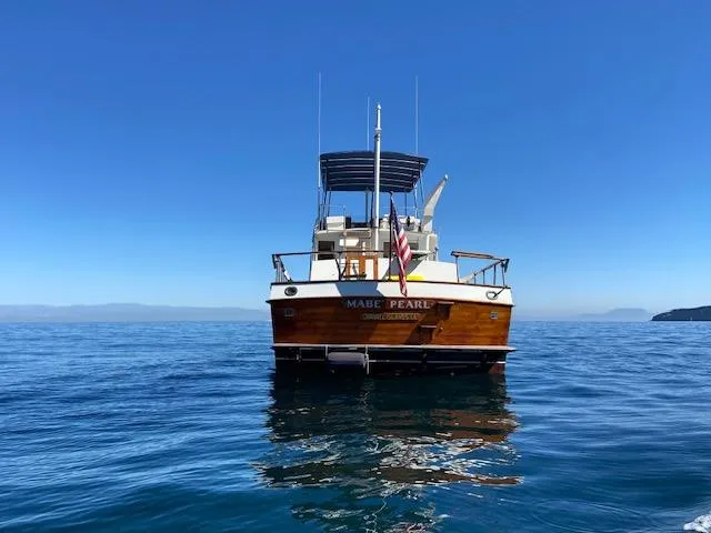 Slide: The Image of 1969 Grand Banks 42 Classic yacht on calm blue sea under clear sky. - 39