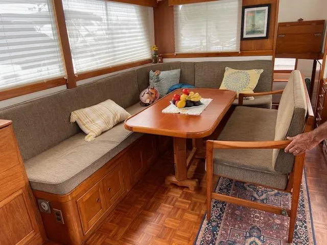 Slide: The Image of Interior of 1969 Grand Banks 42 Classic with cozy dining area and wooden furnishings. - 47