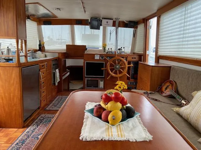 Slide: The Image of Interior of a 1969 Grand Banks 42 Classic yacht with wooden furnishings and fruit centerpiece. - 48