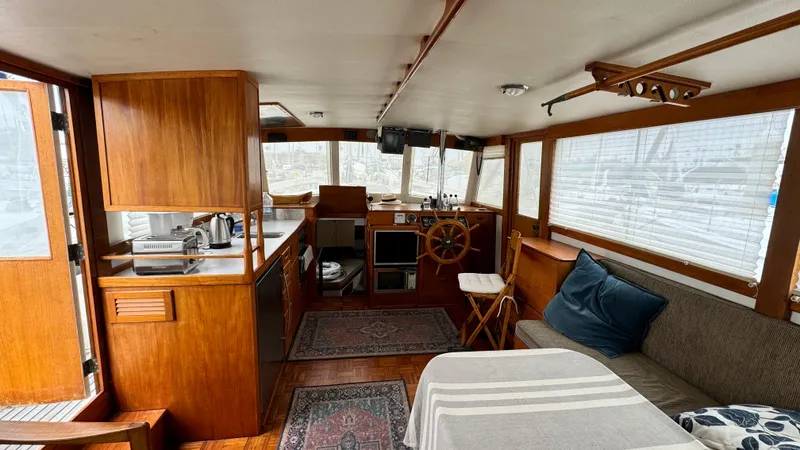 Slide: The Image of Interior of 1969 Grand Banks 42 Classic yacht with wooden cabinetry and cozy seating area. - 5