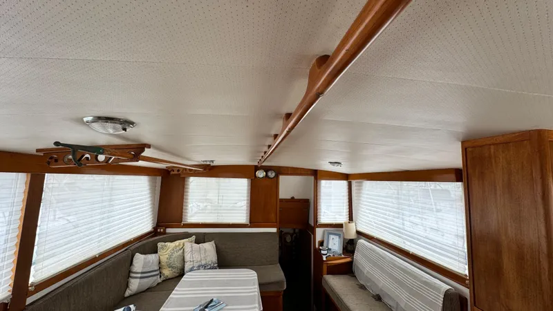 Slide: The Image of Interior of a 1969 Grand Banks 42 Classic yacht with cozy seating and wooden accents. - 8