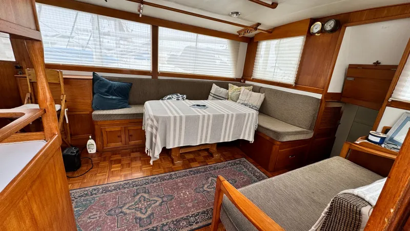 Slide: The Image of Interior of a 1969 Grand Banks 42 Classic yacht with cozy seating and wooden decor. - 9