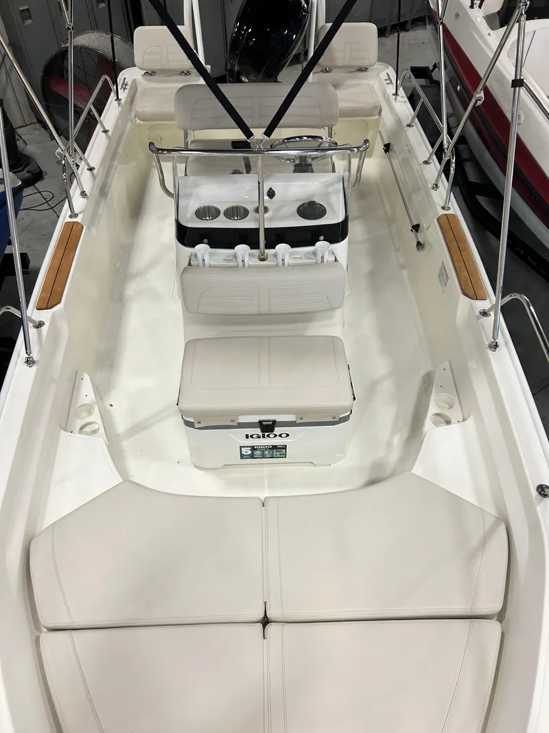Slide: The Image of 2024 Boston Whaler 170 Montauk boat interior with seating and console. - 3