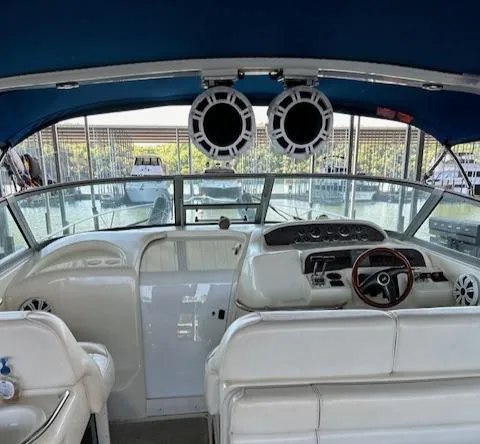 Slide: The Image of Interior view of 1997 Sea Ray 330 Sundancer boat with blue canopy and white seating. - 11