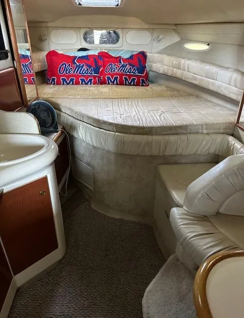 Slide: The Image of 1997 Sea Ray 330 Sundancer cabin interior with bed, sink, and seating. - 3