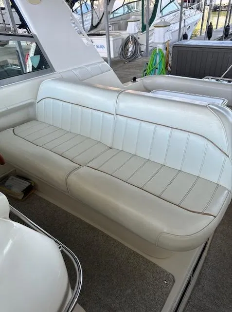 Slide: The Image of 1997 Sea Ray 330 Sundancer boat interior with white leather seating. - 7