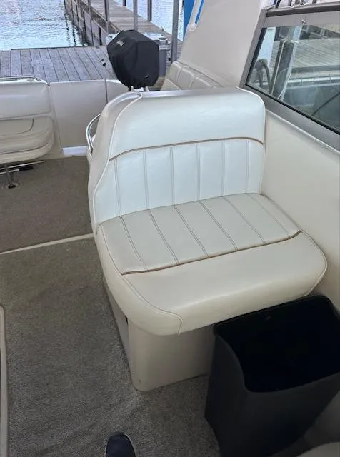 Slide: The Image of Interior seating of a 1997 Sea Ray 330 Sundancer boat with white upholstery. - 8