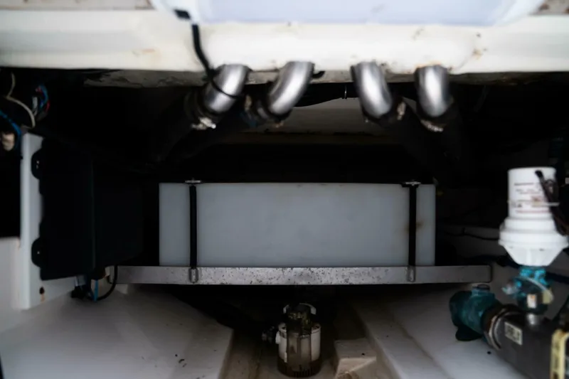 Slide: The Image of 2015 Everglades 325 CC boat engine compartment with fuel tank and hoses. - 30