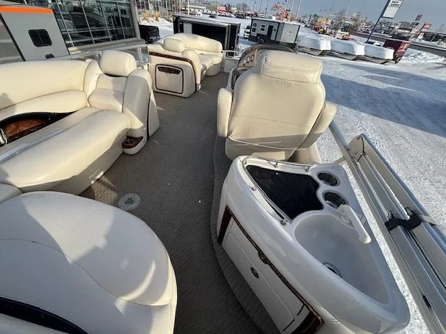 Slide: The Image of 2008 Sun Tracker PARTY BARGE 22 Regency Edition interior with plush seating and helm. - 10
