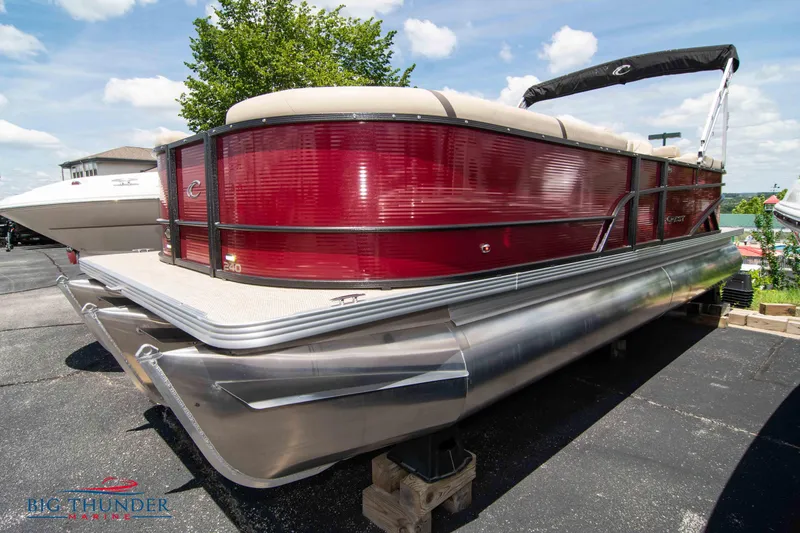 The Image of 2023 Crest CLASSIC LX 240 SLC pontoon boat in red, docked on land. - 0