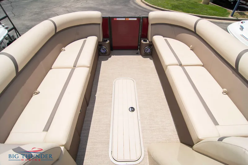 Slide: The Image of 2023 Crest CLASSIC LX 240 SLC pontoon boat interior with beige seating. - 10