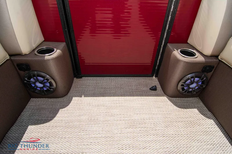 Slide: The Image of 2023 Crest CLASSIC LX 240 SLC boat interior with speakers and cup holders. - 11