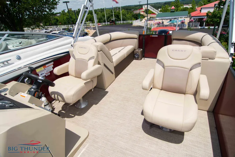 Slide: The Image of 2023 Crest CLASSIC LX 240 SLC boat interior with beige seating and helm. - 13